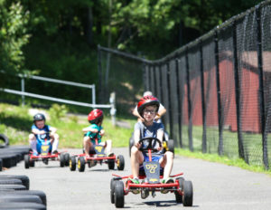 A boy in the lead with racers behind him