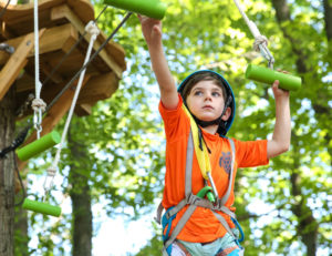 a boy climbing with a harness