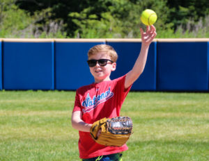 A young boy throwing a softball