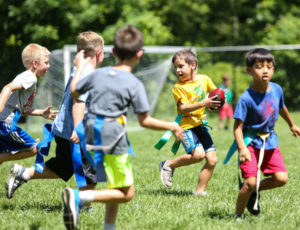 a group of kids playing flag football