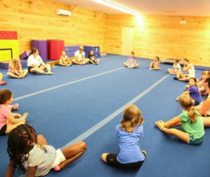 a group of campers in a circle stretching