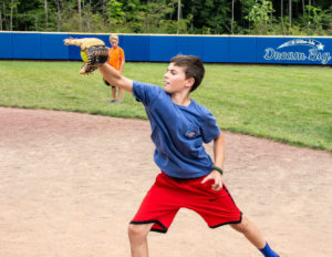 A boy holding his mitt to catch a ball