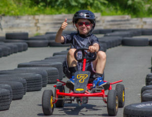 A boy with his thumb up on the track