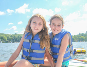 two girls wearing life vests