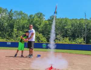 a boy and a counselor launch a rocket