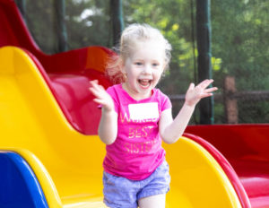 a little girl excitedly waving her hands