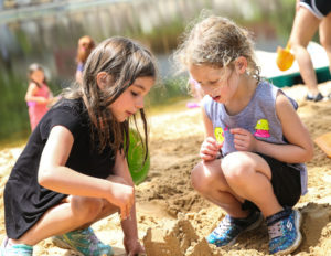 two girls building a sand castle