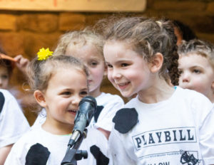 two girls sharing a microphone dressed as cowz