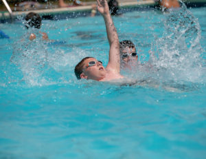 A boy in the middle of a backstroke