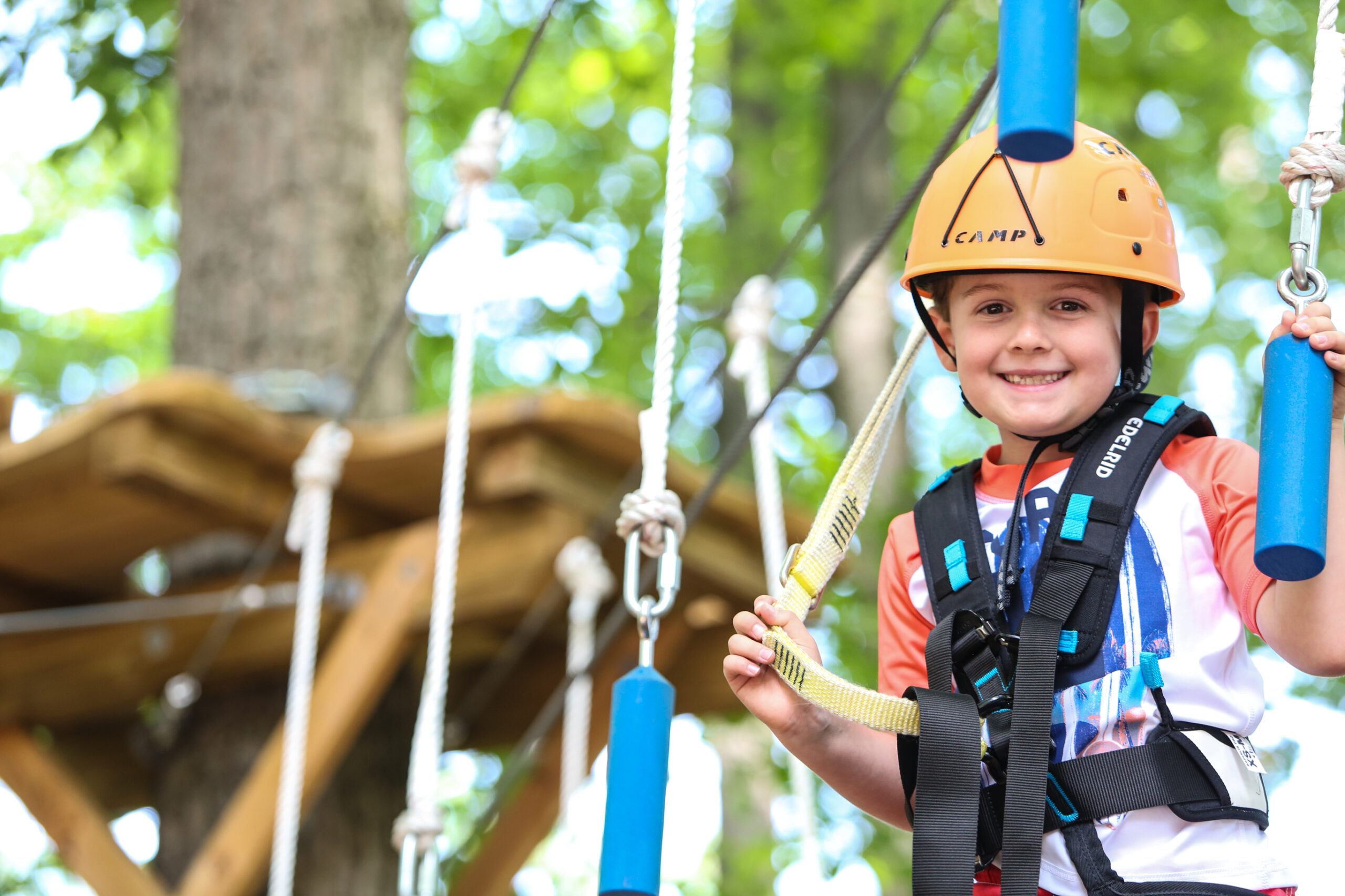 A boy on a ropes course.